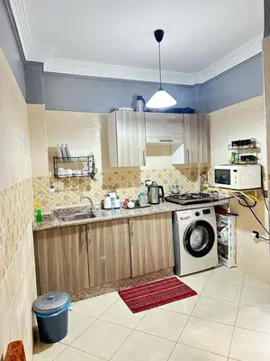 a kitchen with a sink and a washing machine at charming room close to Marrakech airport in Marrakech