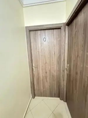 a wooden door in a room with a tile floor at charming room close to Marrakech airport in Marrakech