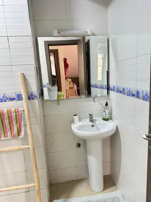 a bathroom with a sink and a mirror at charming room close to Marrakech airport in Marrakech