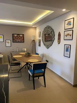 a dining room with a table and chairs at Luxueux Appart Hivernage avec vue sur L''Atlas in Marrakech