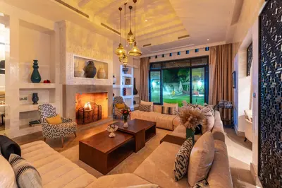 a living room with a couch and a fireplace at Luxury Villa GoldPalm Marrakech in Marrakech