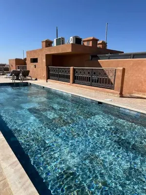 a large swimming pool on top of a building at APP. Traversant au GUELIZ + Piscine sur le toit in Marrakech
