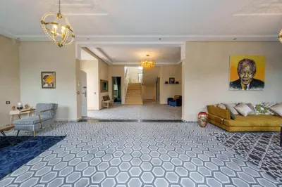 a living room with a couch and a chandelier at Villa Souad 5 Suites - Parking & Piscine Privée in Marrakech