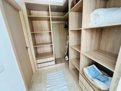 a walk in closet with wooden shelves at Family Palms Luxe Villa Marrakech with Private Pool in Marrakech