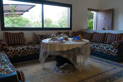a living room with a table and a couch at Family Palms Luxe Villa Marrakech with Private Pool in Marrakech