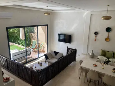 a living room with a couch and a table at Family Palms Luxe Villa Marrakech with Private Pool in Marrakech