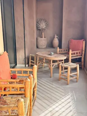 a room with a table and chairs and a table and chairs at Appartement centre Guéliz avec terrasse spacieuse in Marrakech