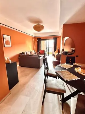 a living room with a couch and a table at Appartement centre Guéliz avec terrasse spacieuse in Marrakech