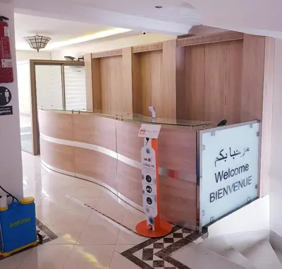 a waiting room with a welcome sign in a building at Hotel Ichbilia فندق اشبيلية in Marrakech