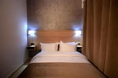a bedroom with a large bed with two pillows at Hotel Ichbilia فندق اشبيلية in Marrakech
