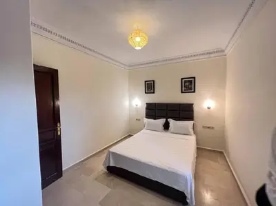a bedroom with a large white bed in a room at The Majestic Marrakesh Villa 2 in Marrakech