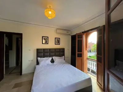 a bedroom with a large bed and a window at The Majestic Marrakesh Villa 2 in Marrakech