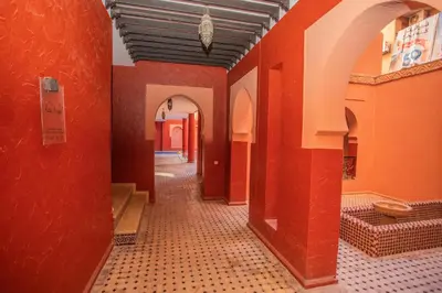 an empty hallway with red walls and tile floors at Apartamento Residencia Kasbah de Marrakech 1 Gueliz in Marrakech