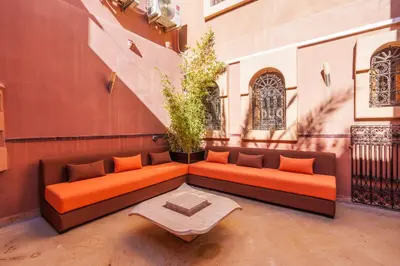 an orange couch sitting on the side of a building at Luxury Villa 6 ROOMS with Pool - Marrakech Center in Marrakech