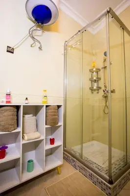 a bathroom with a shower with a glass door at A stunning 2 bedroom Hivernage in Marrakech