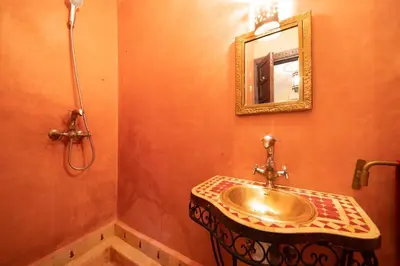 a bathroom with a sink and a mirror at Riad Résidence Al Qaria Assiyahia Riad 22 in Marrakech