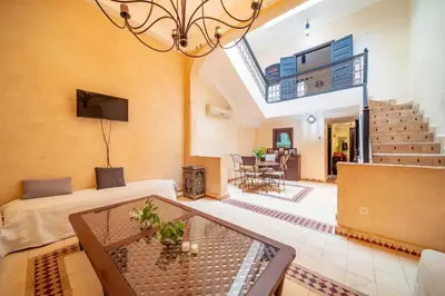 a living room with a couch and a table at Riad Résidence Al Qaria Assiyahia Riad 22 in Marrakech