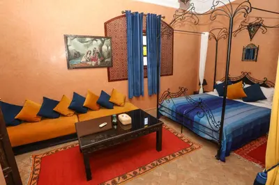 a living room with two beds and a couch at Riad BAHIA in Marrakech