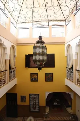 a chandelier hanging from a ceiling in a building at Riad BAHIA in Marrakech