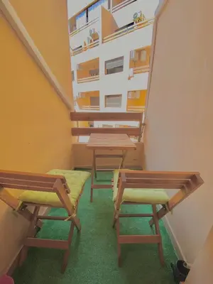 a group of tables and chairs in a room at Appartement avec piscine en face à la gare gueliz in Marrakech