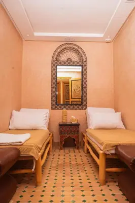 a room with two beds and a mirror at Le Palais Averroes - Adults Only in Marrakech