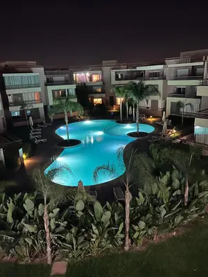 an image of a swimming pool at night at Appart avec Piscine, Riad Garden in Marrakech