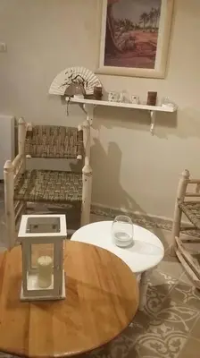 a living room with a table and a bench and shelf at Maison Alegria , Heart of Medina in Marrakech