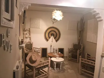 a dining room with a table and chairs and a chandelier at Maison Alegria , Heart of Medina in Marrakech
