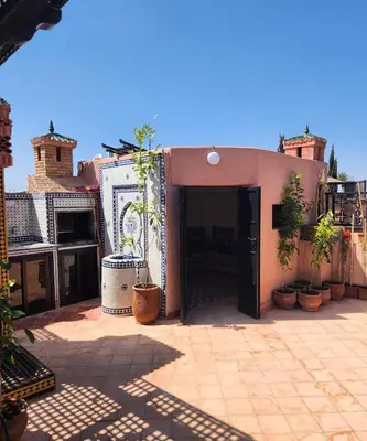 a building with a courtyard with potted plants in it at Tres joli Apparemment atlas golf rosort by marwa € ilyes in Marrakech