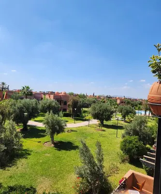 a view of a park with trees and buildings at Tres joli Apparemment atlas golf rosort by marwa € ilyes in Marrakech