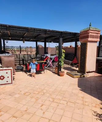 a young child standing in a patio with a pavilion at Tres joli Apparemment atlas golf rosort by marwa € ilyes in Marrakech