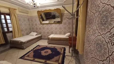 a living room with a couch and a mirror at Stay with low budget in Marrakech