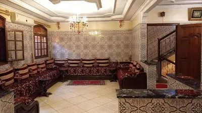 a large waiting room with leather chairs and a chandelier at Stay with low budget in Marrakech