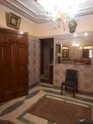 a room with a door and a chair and a mirror at Stay with low budget in Marrakech