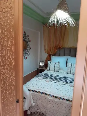 a bedroom with a bed with a canopy at RIAD FOUZIA in Marrakech