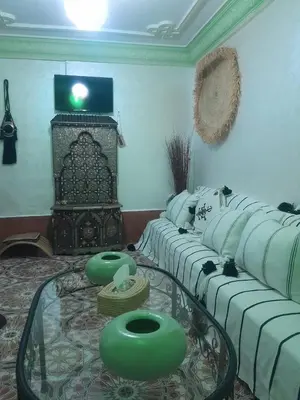 a living room with a couch and a glass table at RIAD FOUZIA in Marrakech