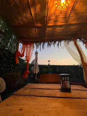 a tent with a bed and a table with a sunset at RIAD FOUZIA in Marrakech