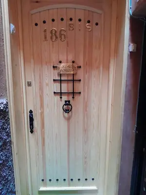 a wooden door with the number on it at RIAD FOUZIA in Marrakech