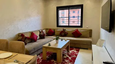 a living room with a couch and a table at Magnifique appartement Marrakech in Marrakech