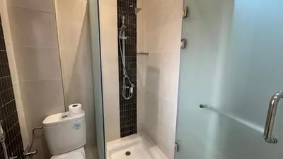 a bathroom with a toilet and a glass shower stall at Magnifique appartement Marrakech in Marrakech