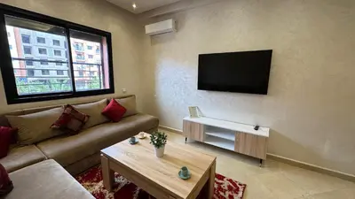 a living room with a couch and a flat screen tv at Magnifique appartement Marrakech in Marrakech