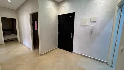 a hallway with a black door in a room at Magnifique appartement Marrakech in Marrakech