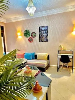 a living room with a couch and a table at Appartement Marrakech Hivernage N54 RESIDENCE CAPRICE PALACE in Marrakech