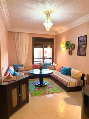 a living room with a couch and a table at Appartement Marrakech Hivernage N54 RESIDENCE CAPRICE PALACE in Marrakech