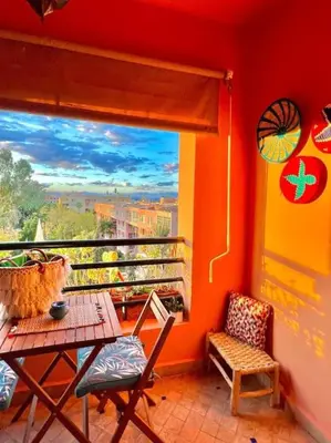 a balcony with a table and chairs and a window at Appartement Marrakech Hivernage N54 RESIDENCE CAPRICE PALACE in Marrakech