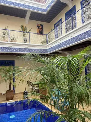 a room with blue and white ceilings and plants at Le riad de Salima, Noor Es Saadi design in Marrakech