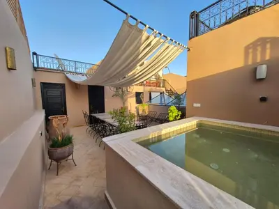 a swimming pool in the backyard of a house at Riad l'Empire in Marrakech