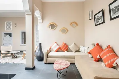 a living room with a couch and a table at Riad l'Empire in Marrakech