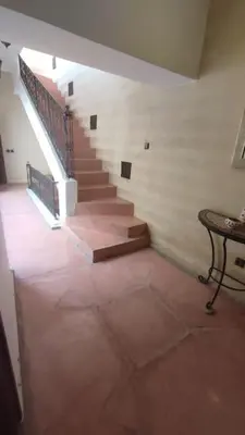 a staircase in a building with a table in a room at RIAD PRIVATISÉ 3 Chambres 6 Personnes Place Jemma El Fna in Marrakech