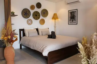 a bed in a room with plates on the wall at STUDIO MODERNE PROCHE MACDO RTE CASA in Marrakech